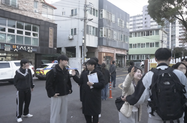 한 교사가 자신의 수험생이 수능을 보러 오자 긴장을 풀어주며 응원의 메시지를 보냈다. [사진=우종희 기자]